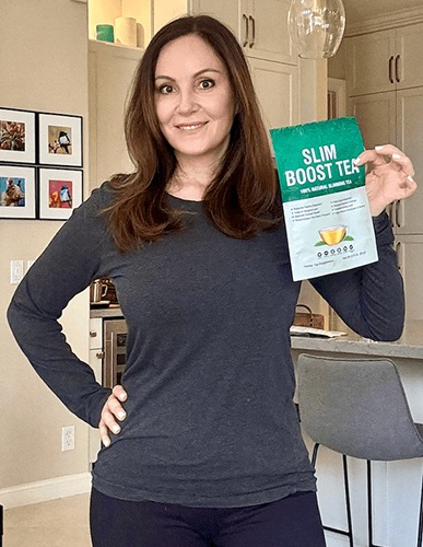 women holding slim boost tea bag
